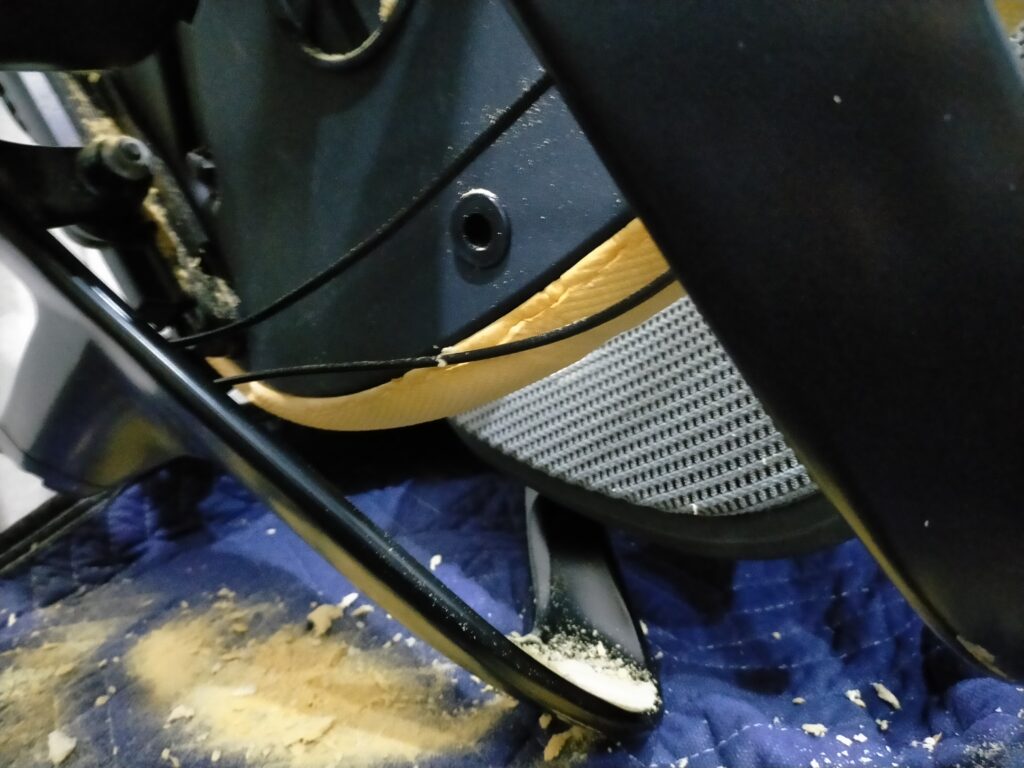 オカムラ コンテッサの座面カバーを取り外した直後に現れた加水分解で崩壊した黄色いウレタン粉が大量に落ちている状態。中古購入品の座面ウレタン劣化の典型的な症状で修理前の状態記録