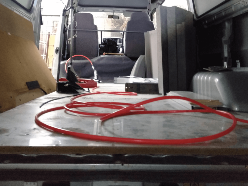 GSメタルシートMS-2を貼り付けたいすゞコモ（E25キャラバン）の床面に15mm MDFボード（0.5mmアルミ板両面貼り）3枚を車体形状に合わせてカットし敷き詰めた完了状態。この上にフロアタイルを施工して居住空間の床が完成。黄色い燃料タンクはFFヒーター用10Lタンク。床断熱DIYフロア施工完了