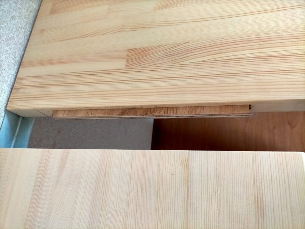 DIY雇いざね接合・20×250mmの雇いざね（12mm合板）をメスザネ溝に差し込んでフィット感を確認している工程。少しきつい場合はジョイントの角をハンマーで叩いて「木殺し」（木繊維を潰して圧縮）してから入れやすくする。無理に押し込むと溝が割れるため木殺しが有効