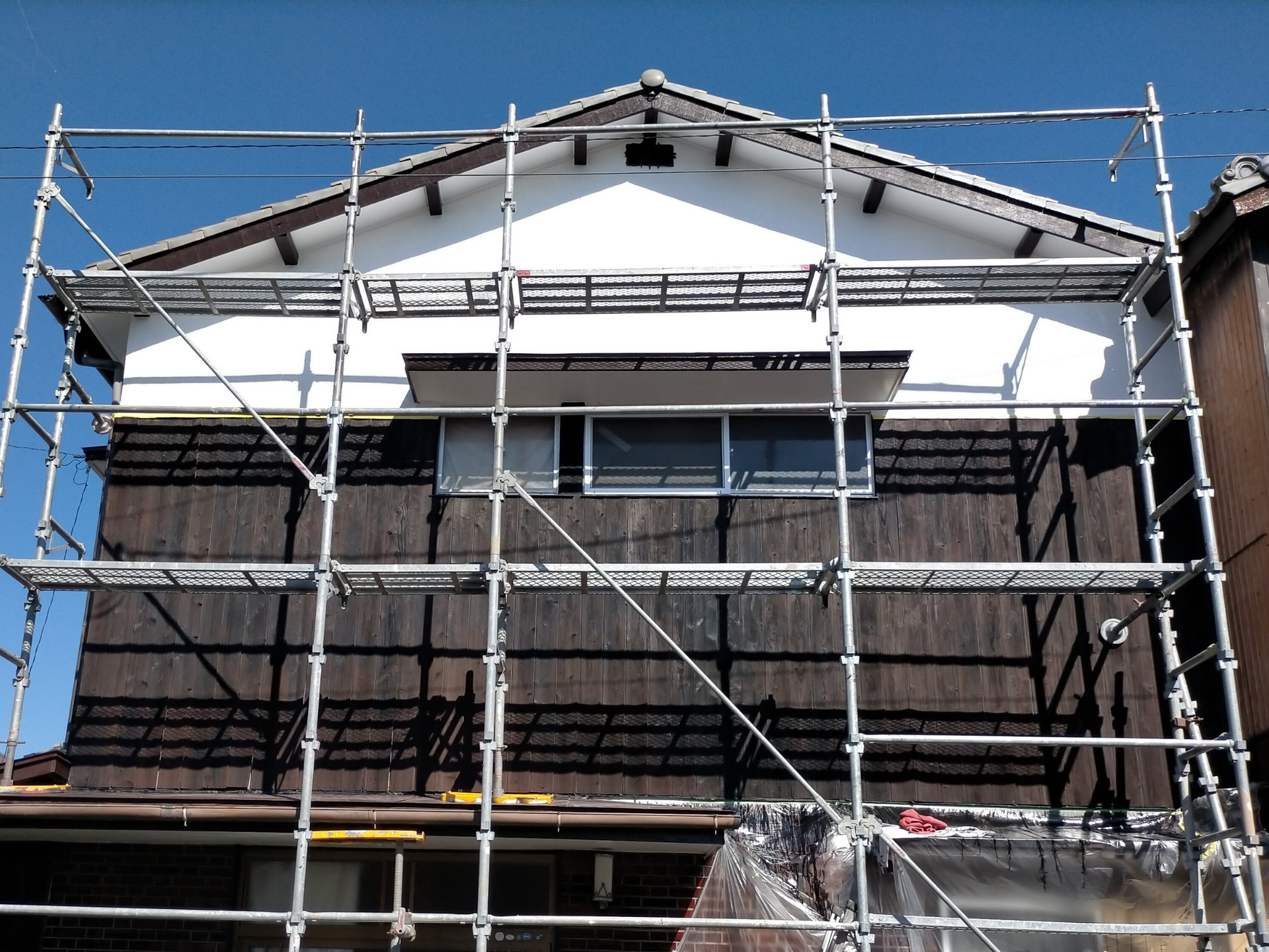 実家の外壁焼杉板にナフタデコール（ロックペイント・キシラデコール同等品で約半額）ブラックを塗装したDIY外壁塗装の完成状態。浸透性木材保護塗料をコーワ防虫防腐剤用はけ平100mmで塗布。モルタル白壁と焼杉ブラックの渋い組み合わせ