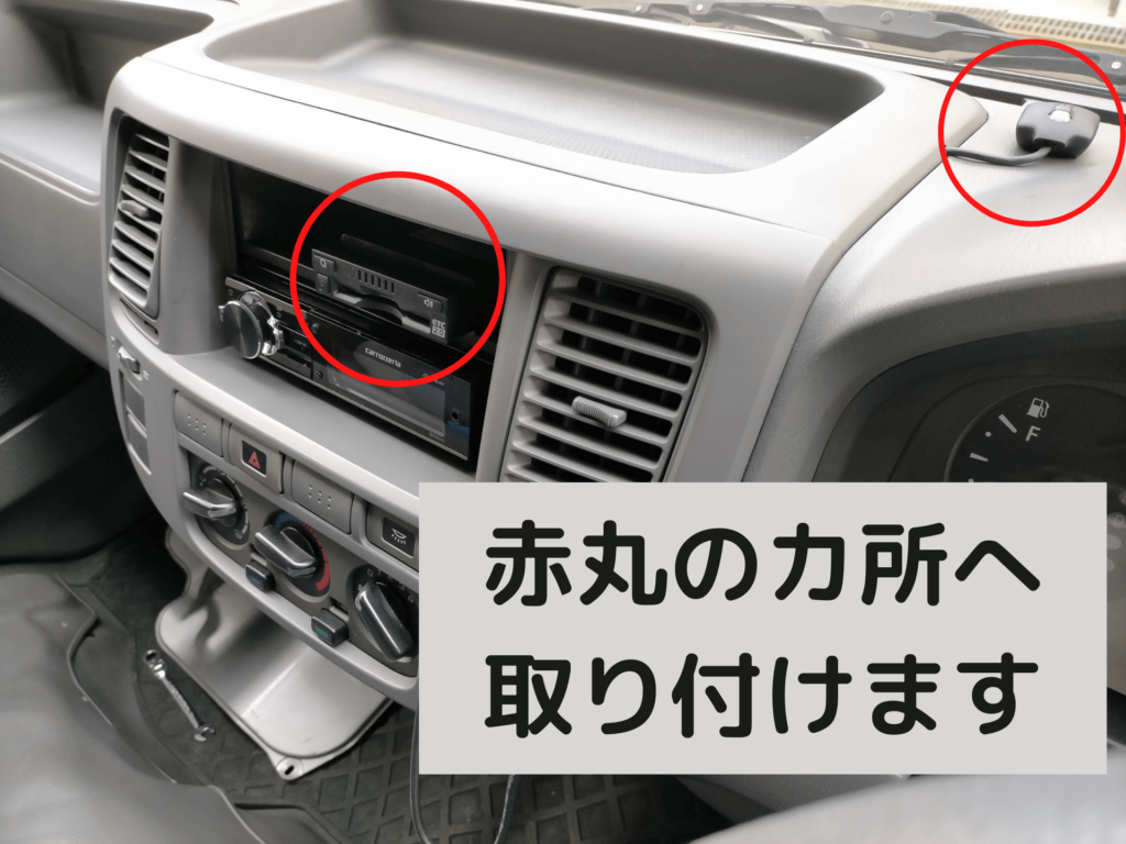 いすゞコモ（E25キャラバン）のセンターコンソール1DINポケットへETC2.0車載器DIU-C010を埋め込む取り付け位置を示した図解。本体を1DINポケット内に隠しアンテナをダッシュボード上に設置するスマートな配置を説明