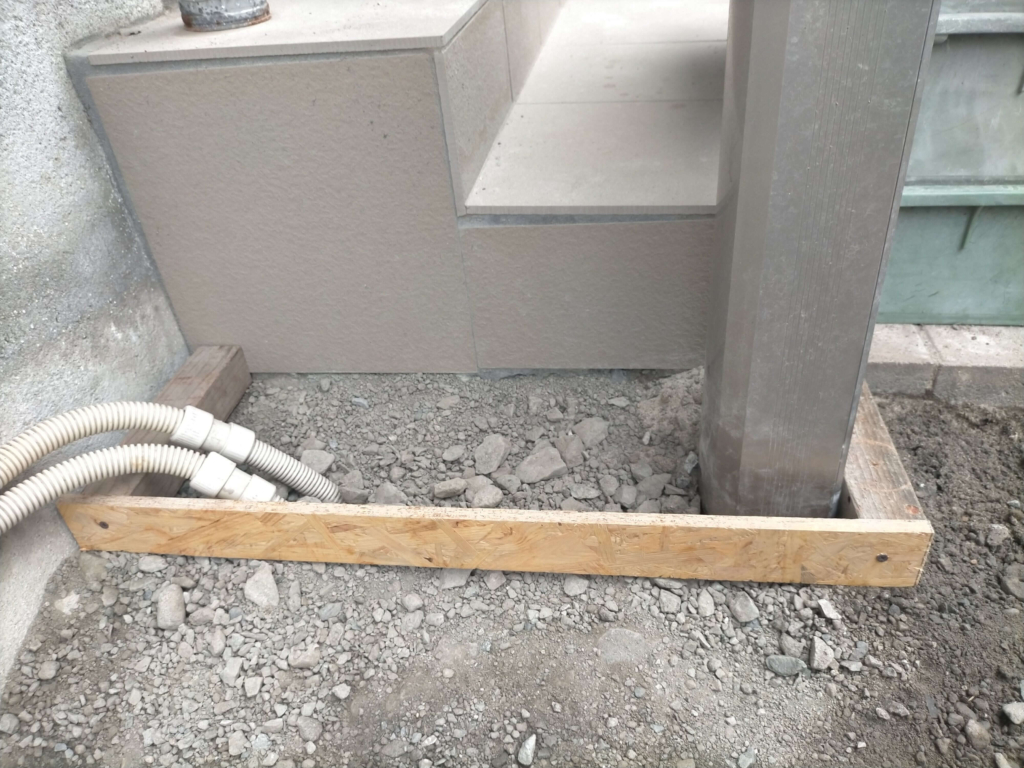 ポーラスコンクリート打設STEP2・廃材の木材で組んだ型枠の設置状態。コスト削減のため廃材を有効活用した型枠。施工面積約5平米（長辺方向）の境界を定めてコンクリートの流出を防ぐ