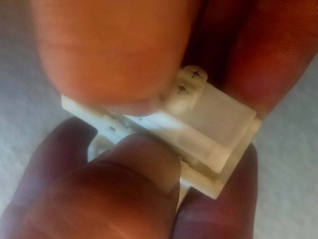 E25キャラバン(いすゞコモ)パワーウィンドウスイッチのスライド部を分解している様子