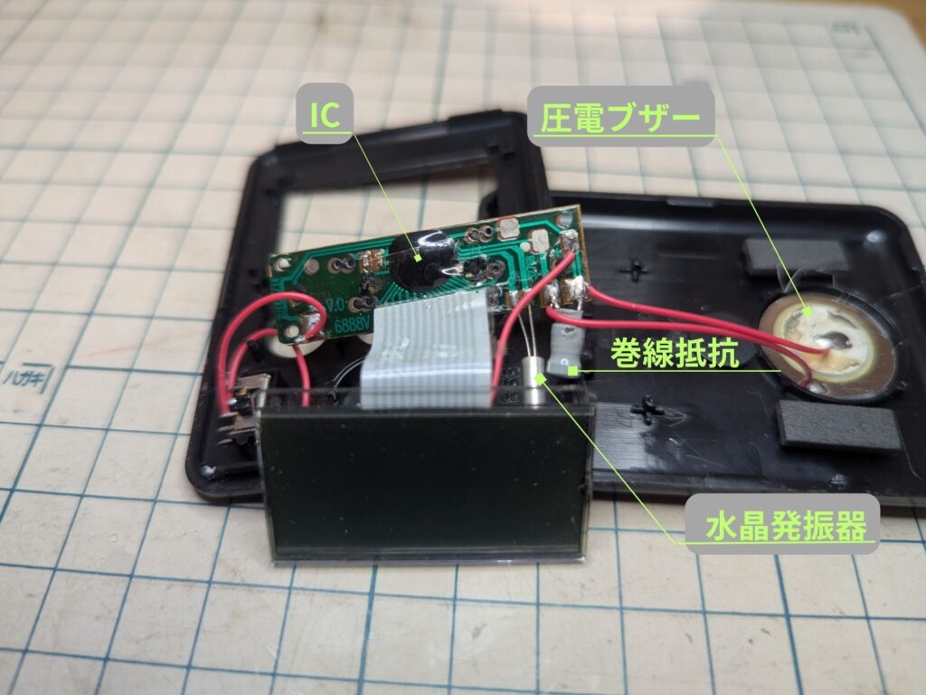 分解したキッチンタイマーの内部部品（IC、圧電ブザー、水晶発振器）の解説図