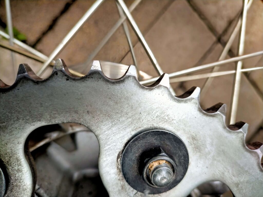 セロー250のリヤスプロケット比較：ガレ場の転倒でついた打痕をグラインダーでの修整後